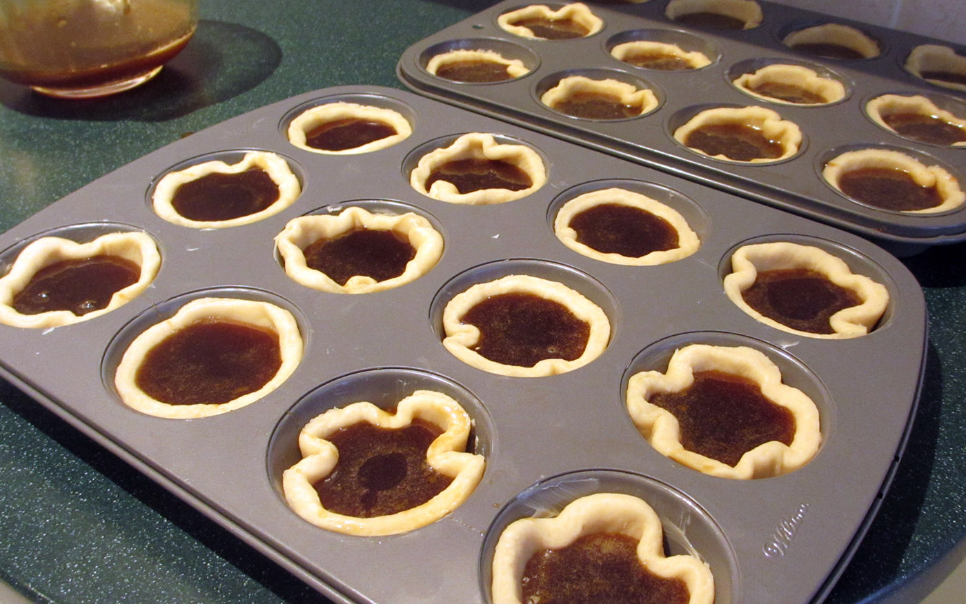 Butter tarts with filling before baking