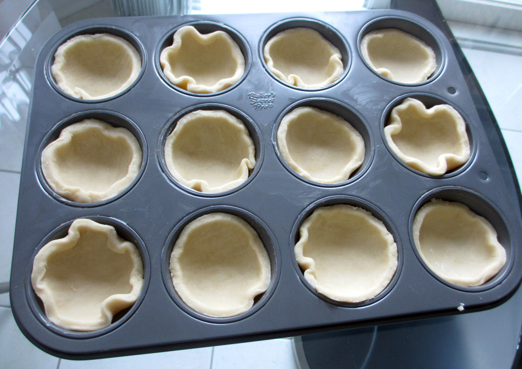 Muffin tin lined with pastry dough